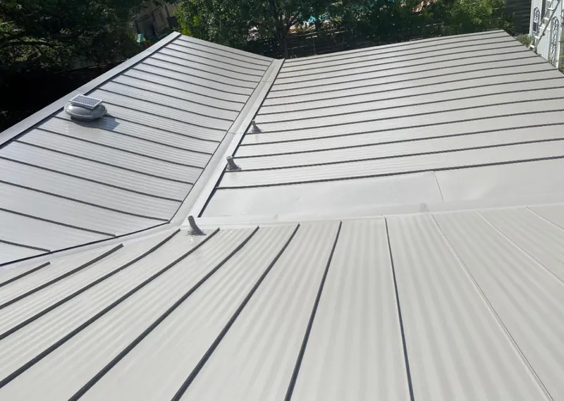 Solar attic fan installed on a metal roof for Roof Ventilation in Dobbs Ferry